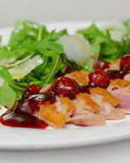 Теплый салат с утиной грудкой, рукколой и вишневым соусом